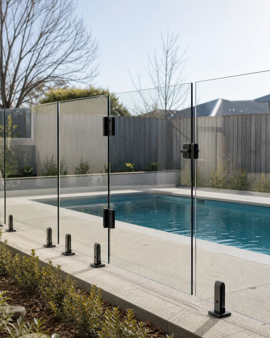 Frameless clear glass pool fence and matching gate with black hardware