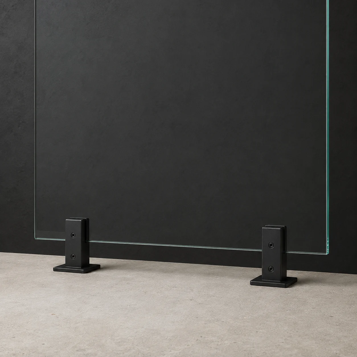 Clear glass panel supported by two black square spigots