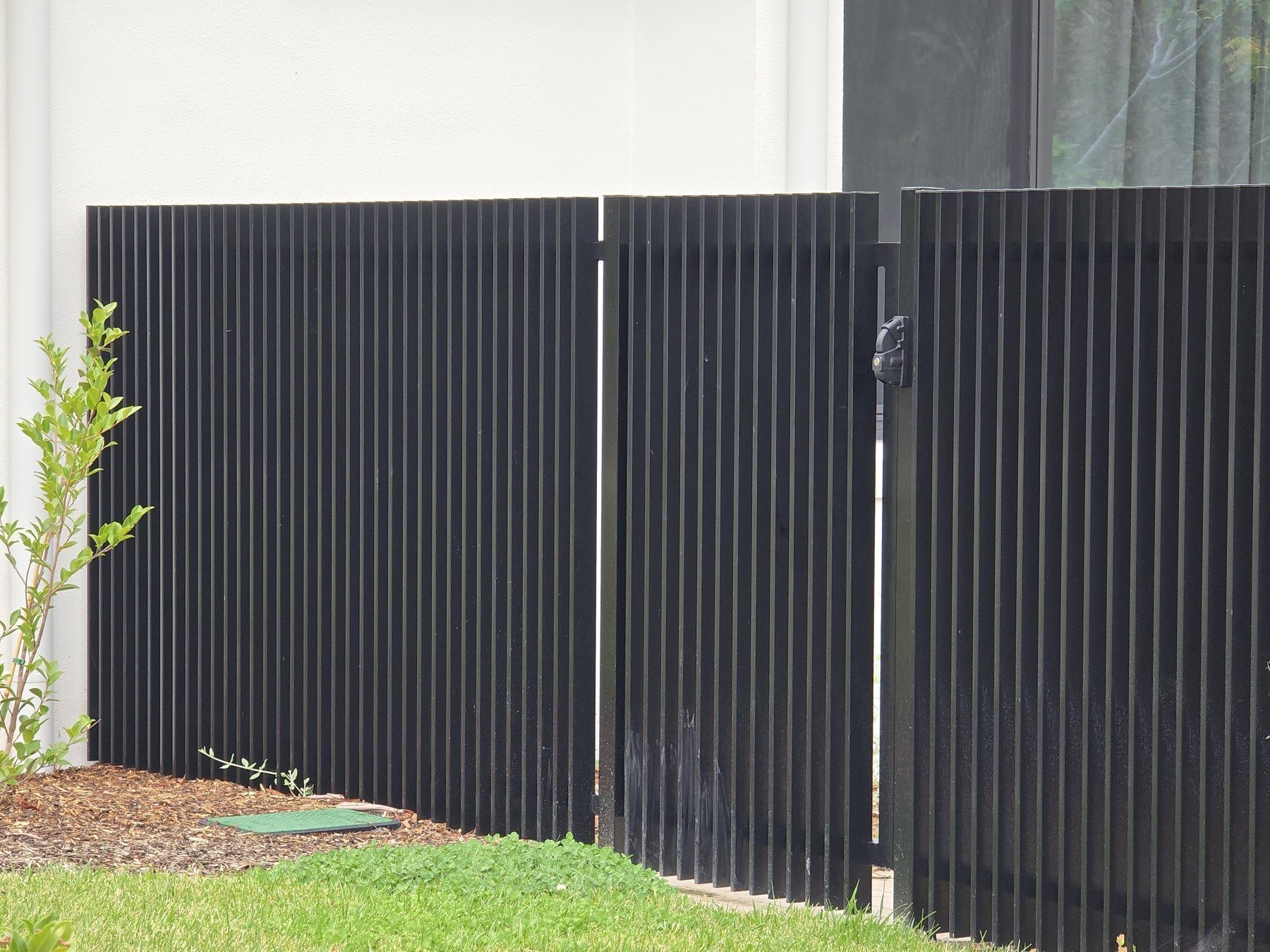 Aluminium blade fencing installed beside landscaping